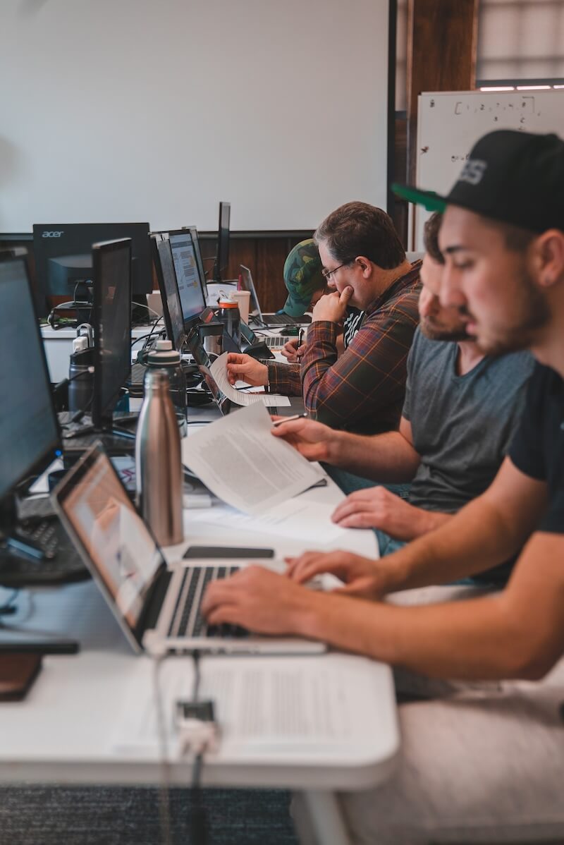 People working on computers at a long desk