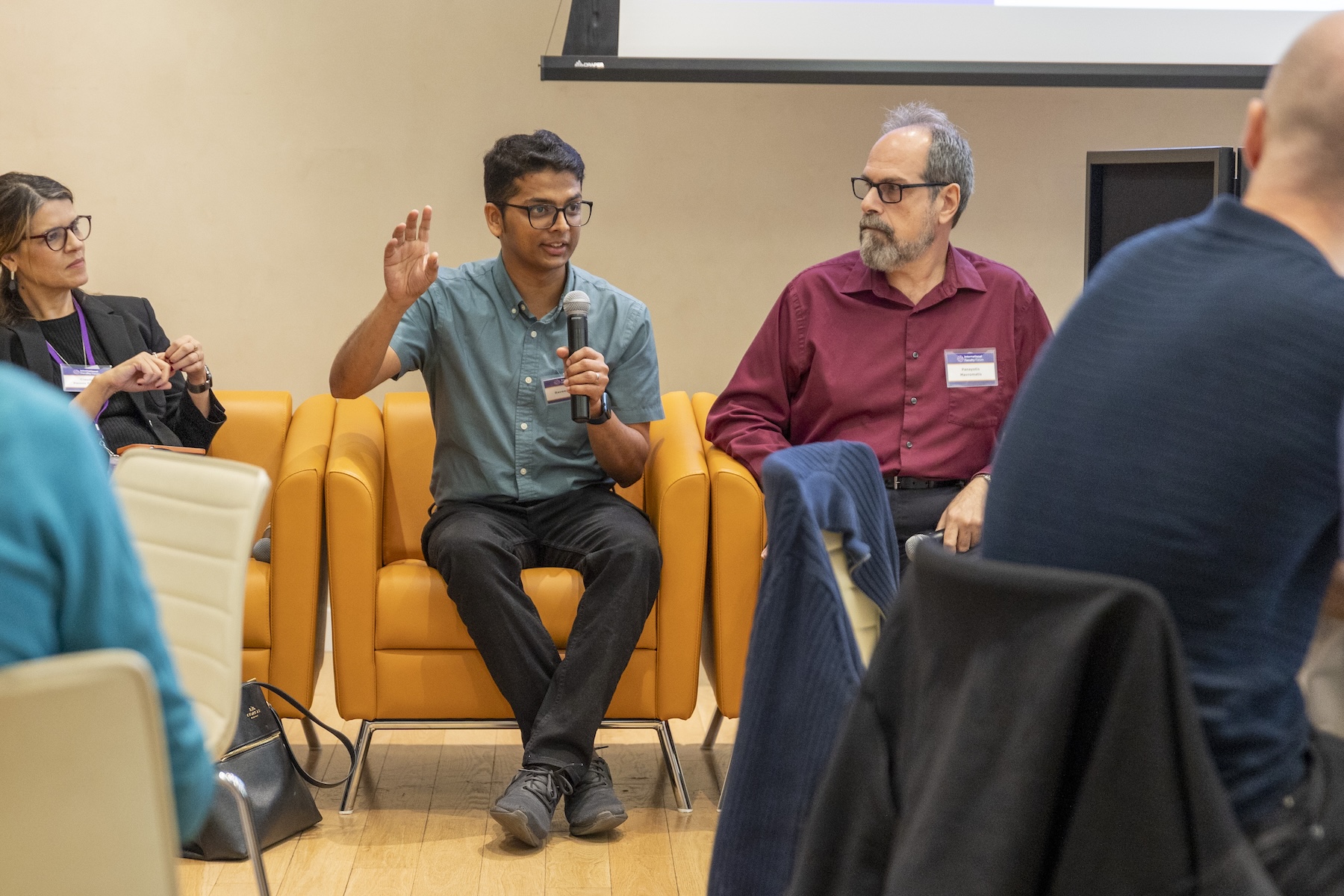Panelists addressing a conference