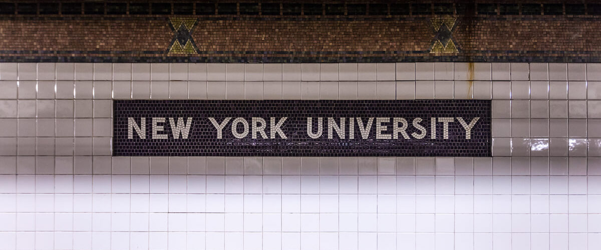 New York University sign on a tiled subway wall