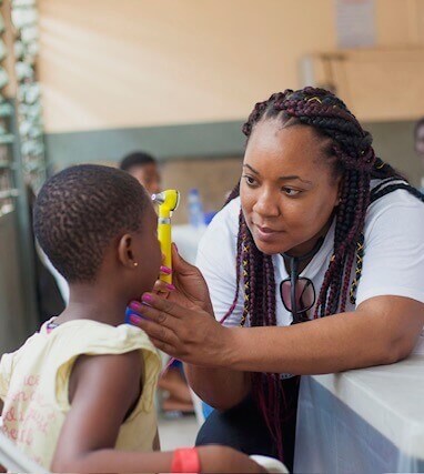 Selena Giles volunteering as a Nurse Practitioner on a medical mission in a rural village in Ghana