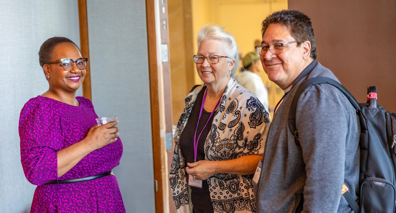 Usheevii King mingling with two other attendees at a Faculty Resource Network event