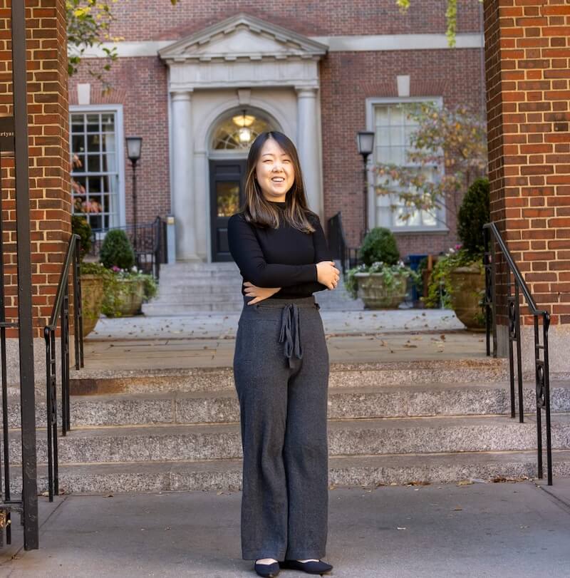 Sunoo Park posing in front of NYU School of Law