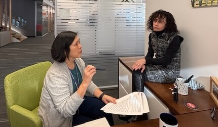 Mindy Tarlow and Tina Chiu in a small office, seated informally and talking